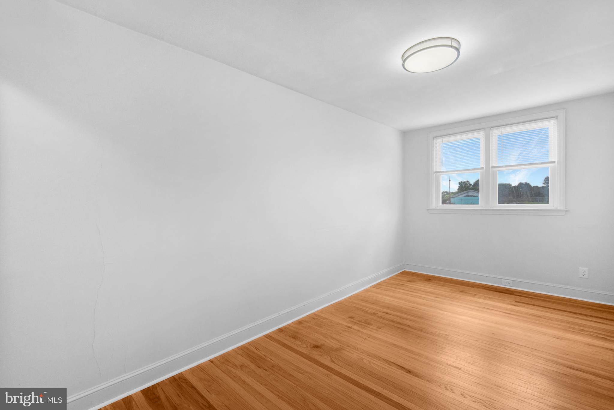 666 Rively Avenue Glenolden, PA 19036 - Photo 4 of 15 a view of a room with wooden floor and windows