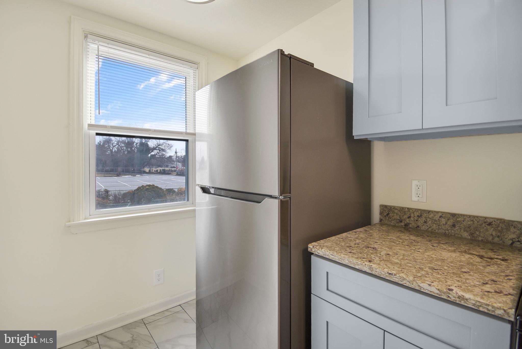 666 Rively Avenue Glenolden, PA 19036 - Photo 5 of 15 a kitchen with metallic cabinets and a refrigerator