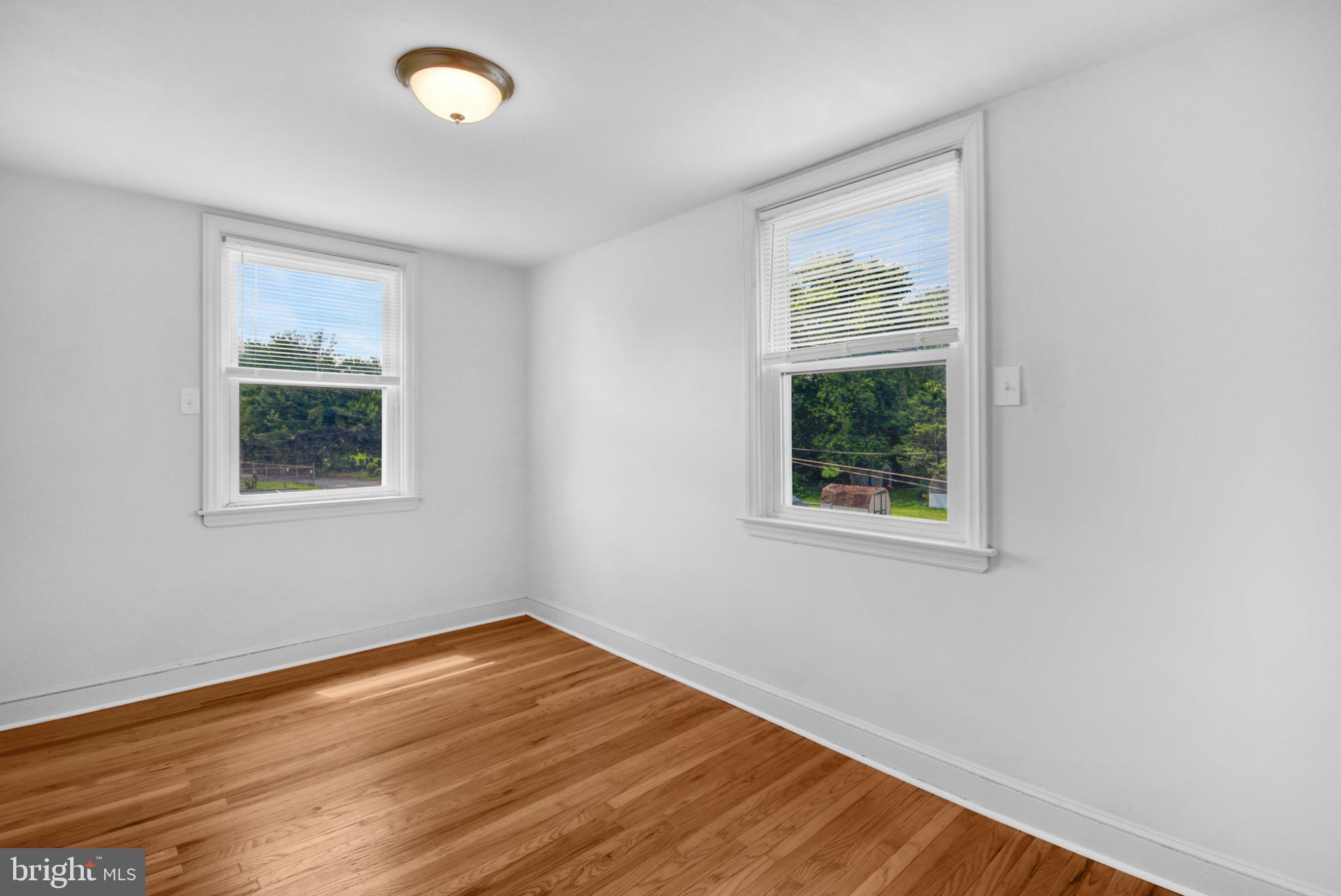 666 Rively Avenue Glenolden, PA 19036 - Photo 7 of 15 a view of an empty room with wooden floor and a window