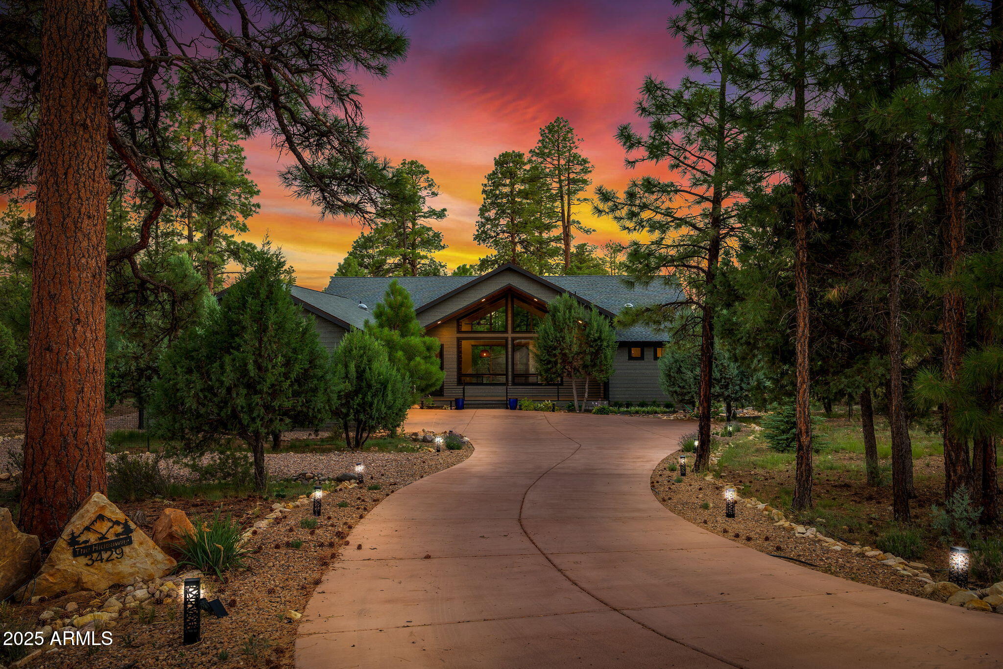 a front view of a house with a yard and tree s