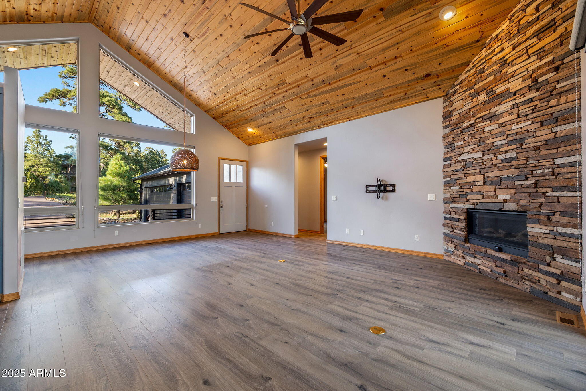 3429 Ponderosa Loop Heber, AZ 85928 - Photo 15 of 75 a view of an empty room with a fireplace and wooden floor