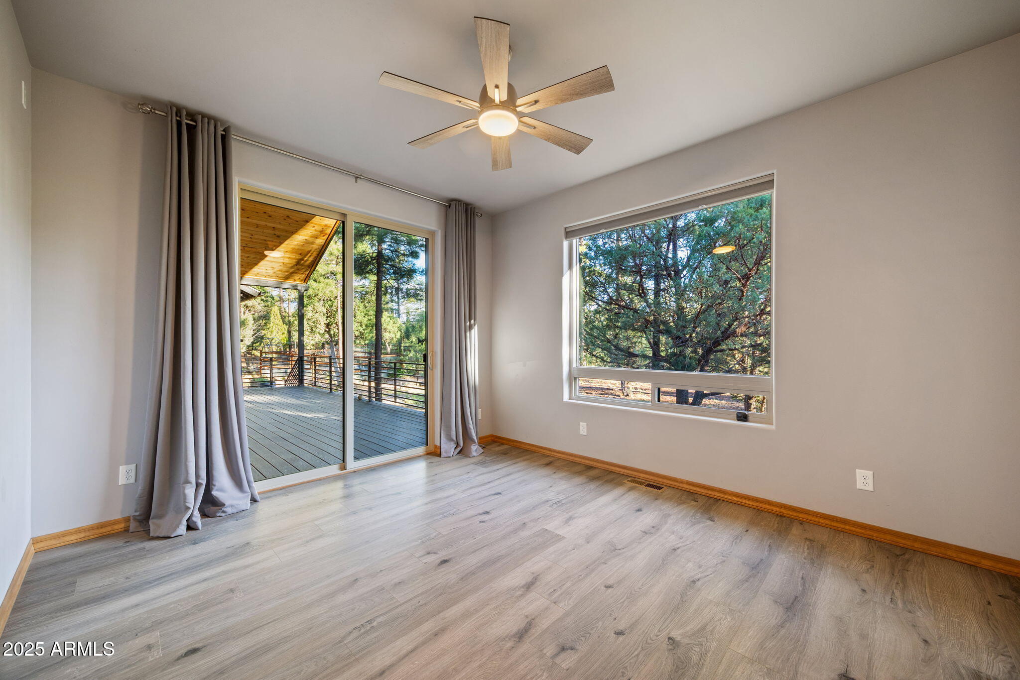3429 Ponderosa Loop Heber, AZ 85928 - Photo 27 of 75 an empty room with wooden floor and windows