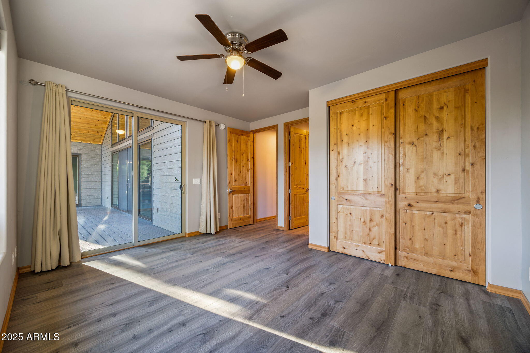 3429 Ponderosa Loop Heber, AZ 85928 - Photo 38 of 75 an empty room with wooden floor and windows