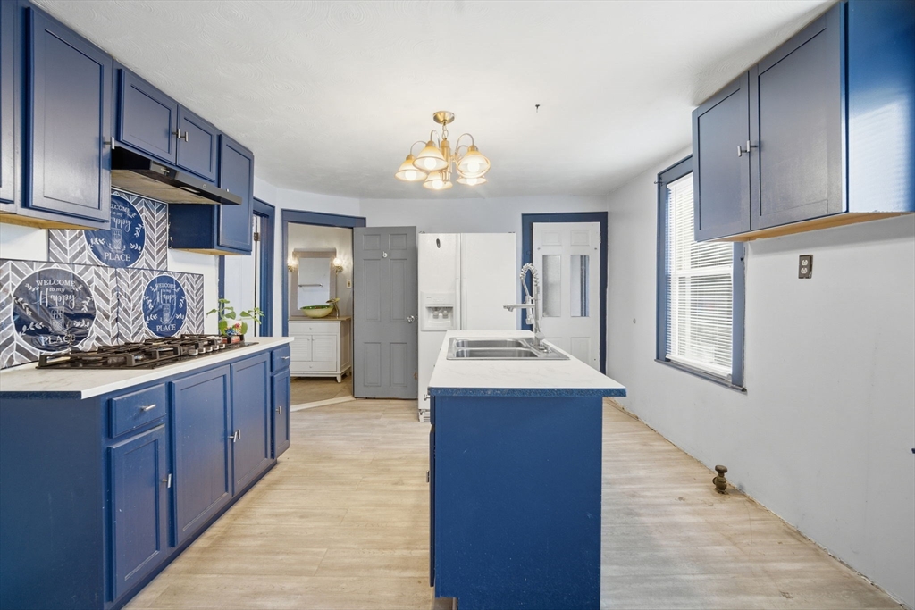 53 Fremont Street Springfield, MA 01105 - Photo 3 of 40 a large kitchen with stainless steel appliances granite countertop a sink and cabinets