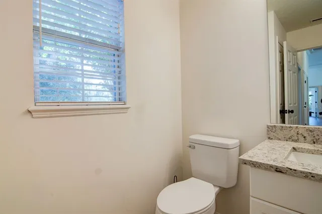 a white toilet sitting next to a bathroom sink