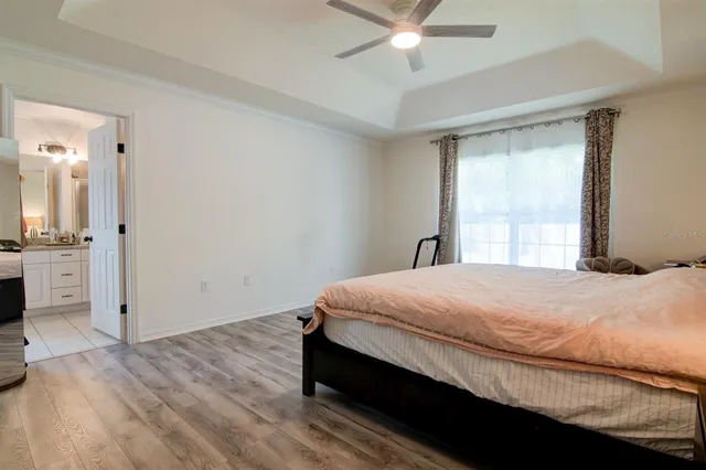 a bedroom with a bed and a chandelier