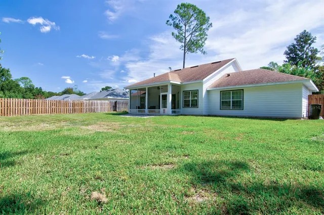 a front view of a house with a garden and yard
