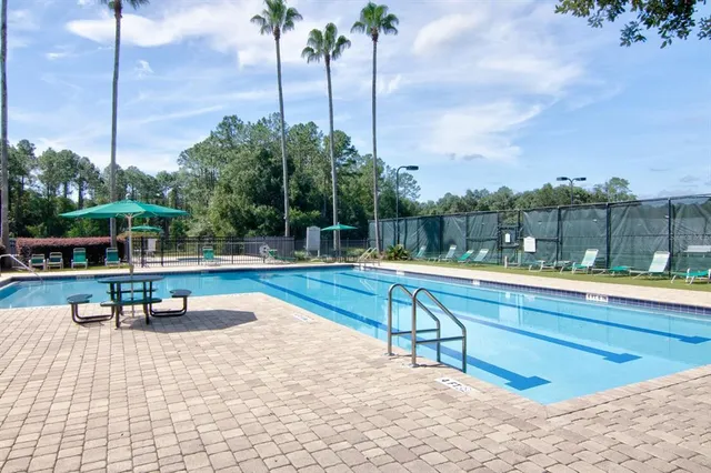 a view of a swimming pool with a lounge chair