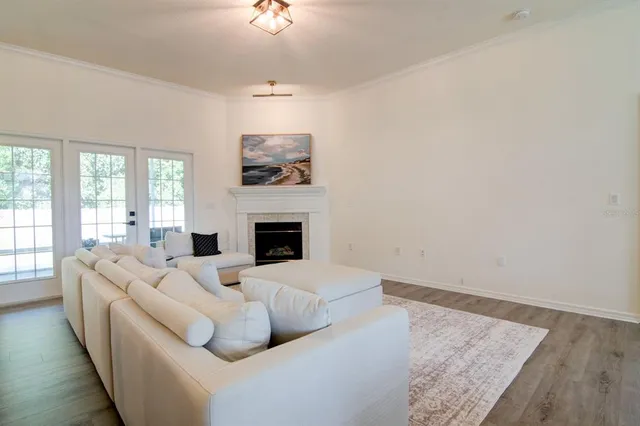 a living room with furniture fireplace and window