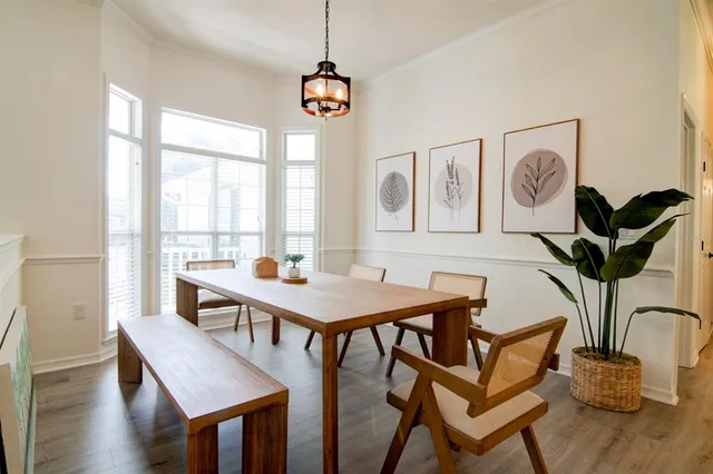 a view of a dining room with furniture window and wooden floor