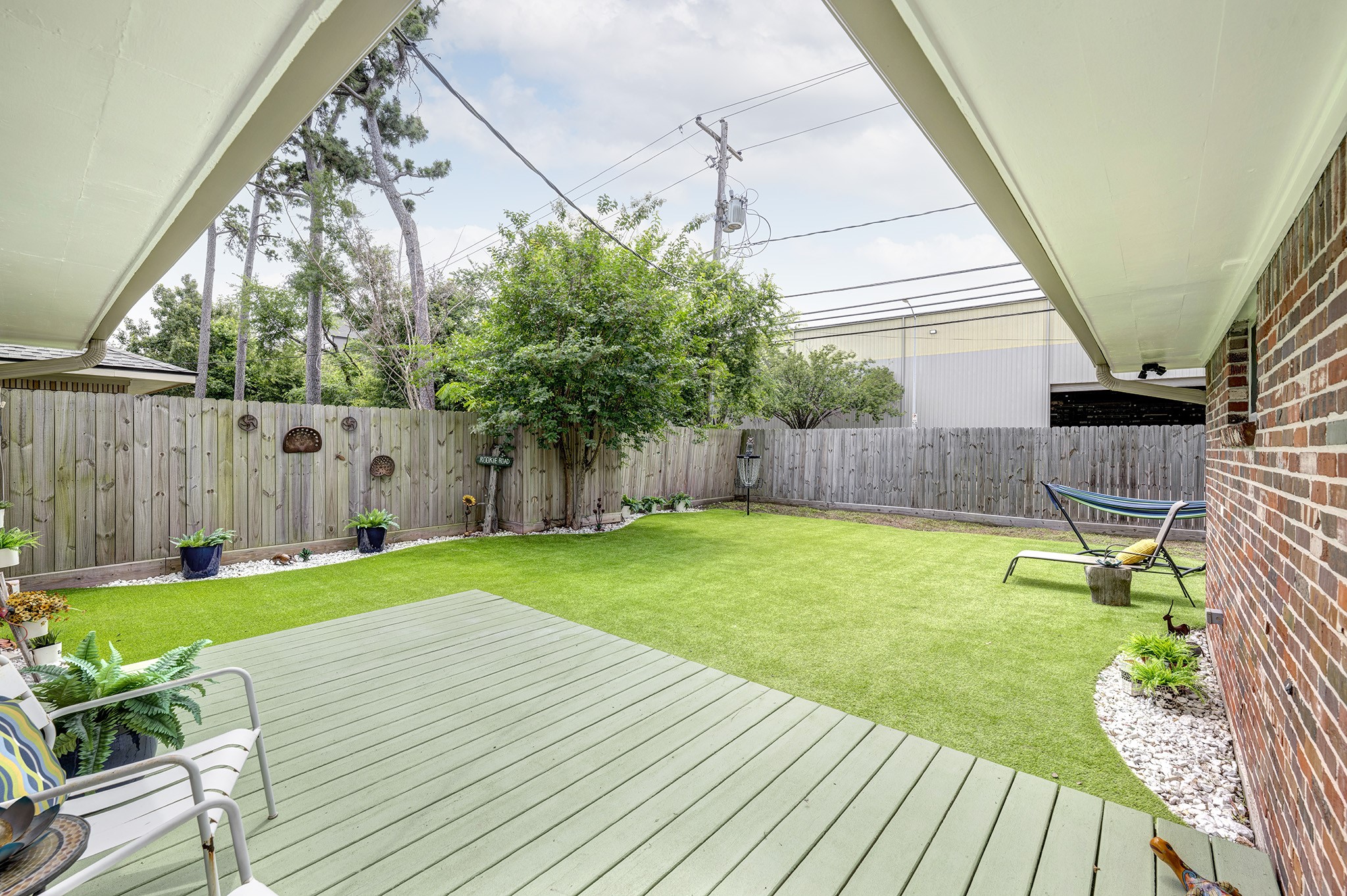 1111 Clovis Road Houston, TX 77008 - Photo 21 of 32 The expansive low-profile backyard deck is over 400 sf in size. The southern half overlooks the turfed area of the rear yard and meandering white-stoned landscaping beds.
