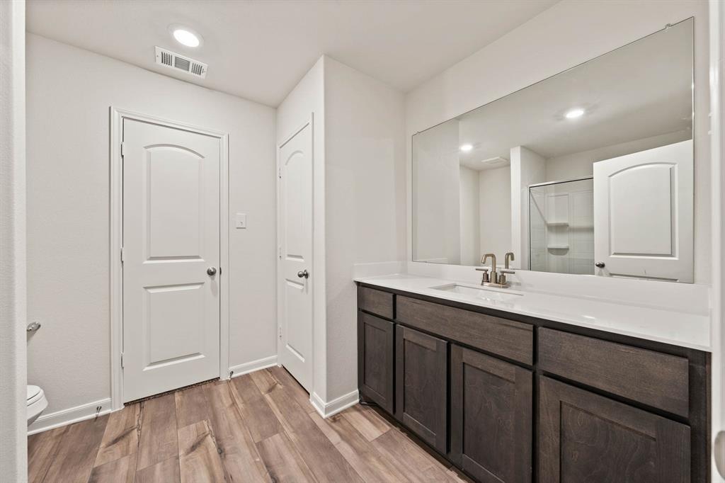 937 Burlington Avenue Fort Worth, TX 76108 - Photo 4 of 5 Full bath featuring wood finished floors, vanity, recessed lighting, and a shower