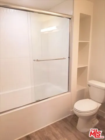a bathroom with a toilet and a shower