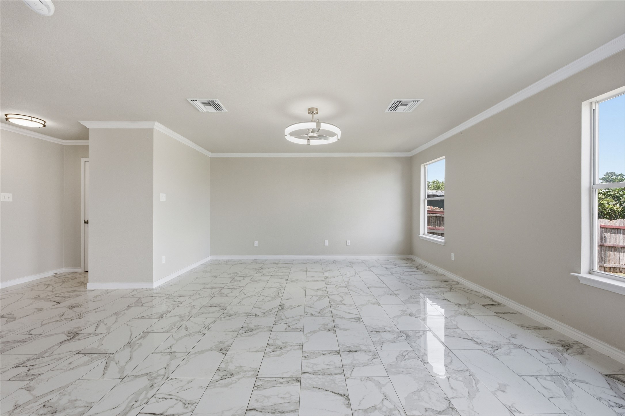 6917 Panda Royle Drive Del Valle, TX 78617 - Photo 6 of 23 Marble-look tile flooring gleams in this spacious, open-concept living area with abundant natural light.