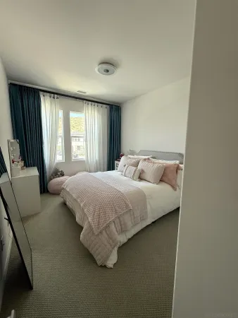 a bedroom with a bed and glass window