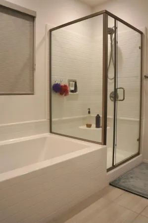 a bathroom with a shower and a bath tub