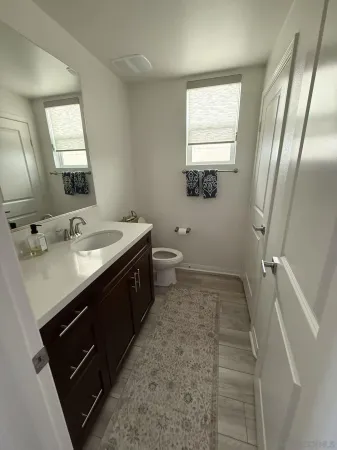 a bathroom with a double vanity sink and mirror