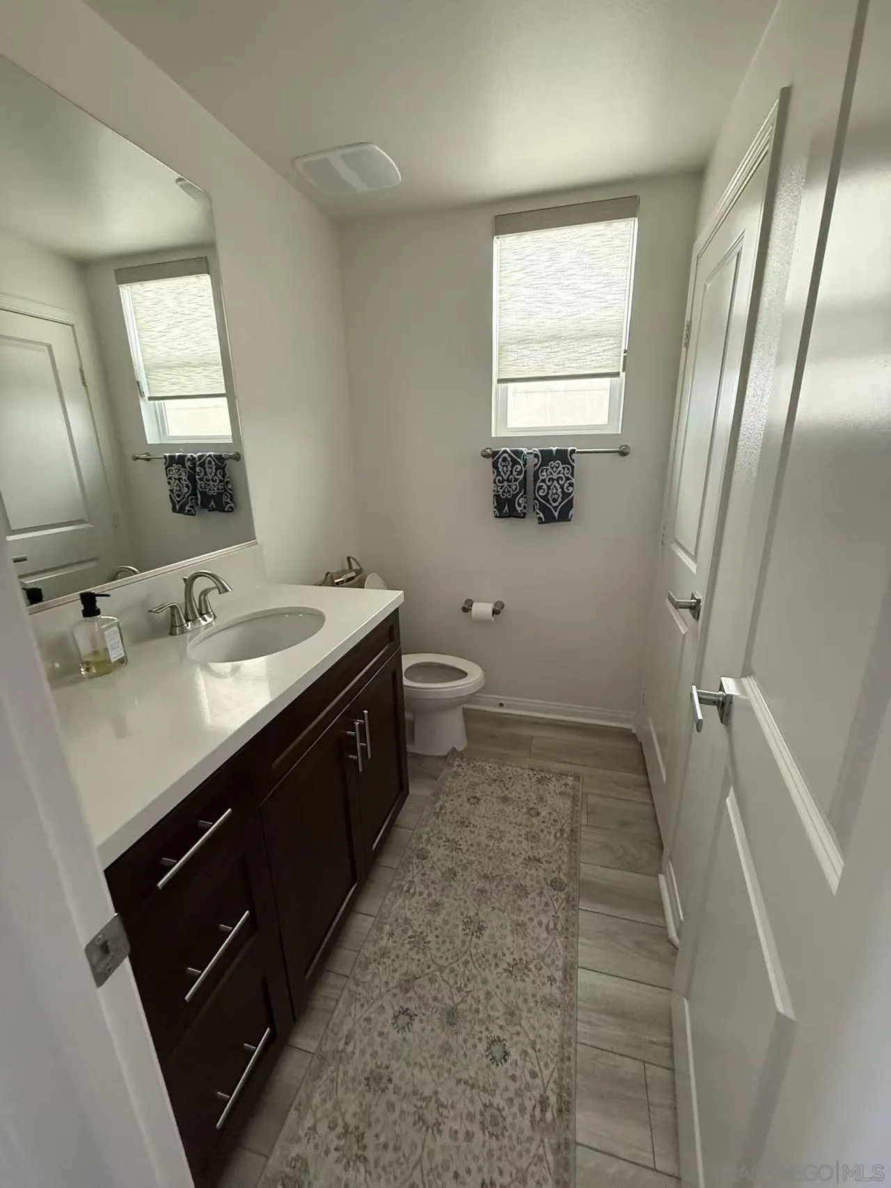 8515 Goldfield Street Santee, CA 92071 - Photo 22 of 34 a bathroom with a double vanity sink and mirror