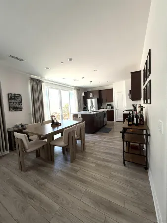 a living room with furniture flat screen tv and window