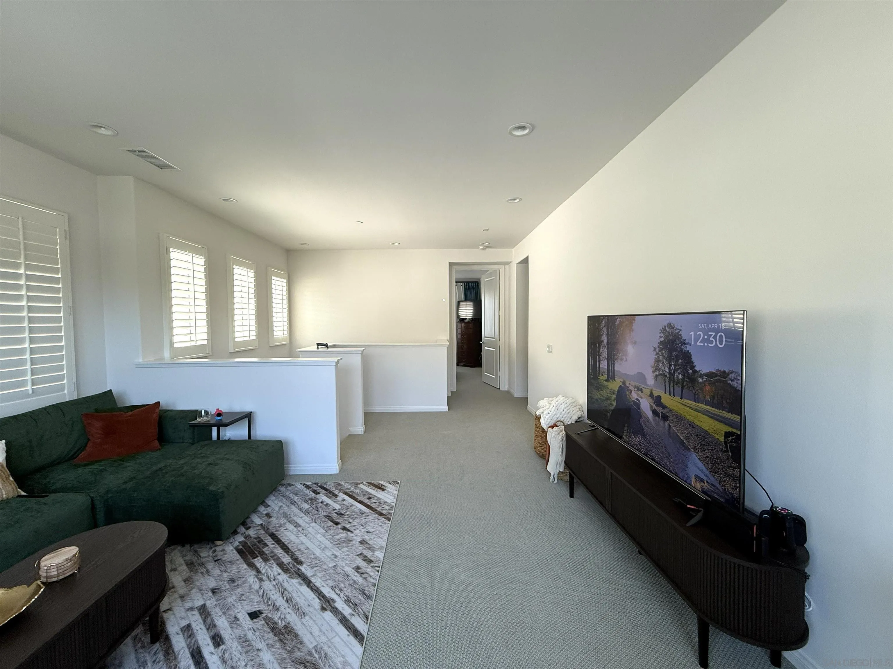 8515 Goldfield Street Santee, CA 92071 - Photo 9 of 34 a living room with furniture and a flat screen tv