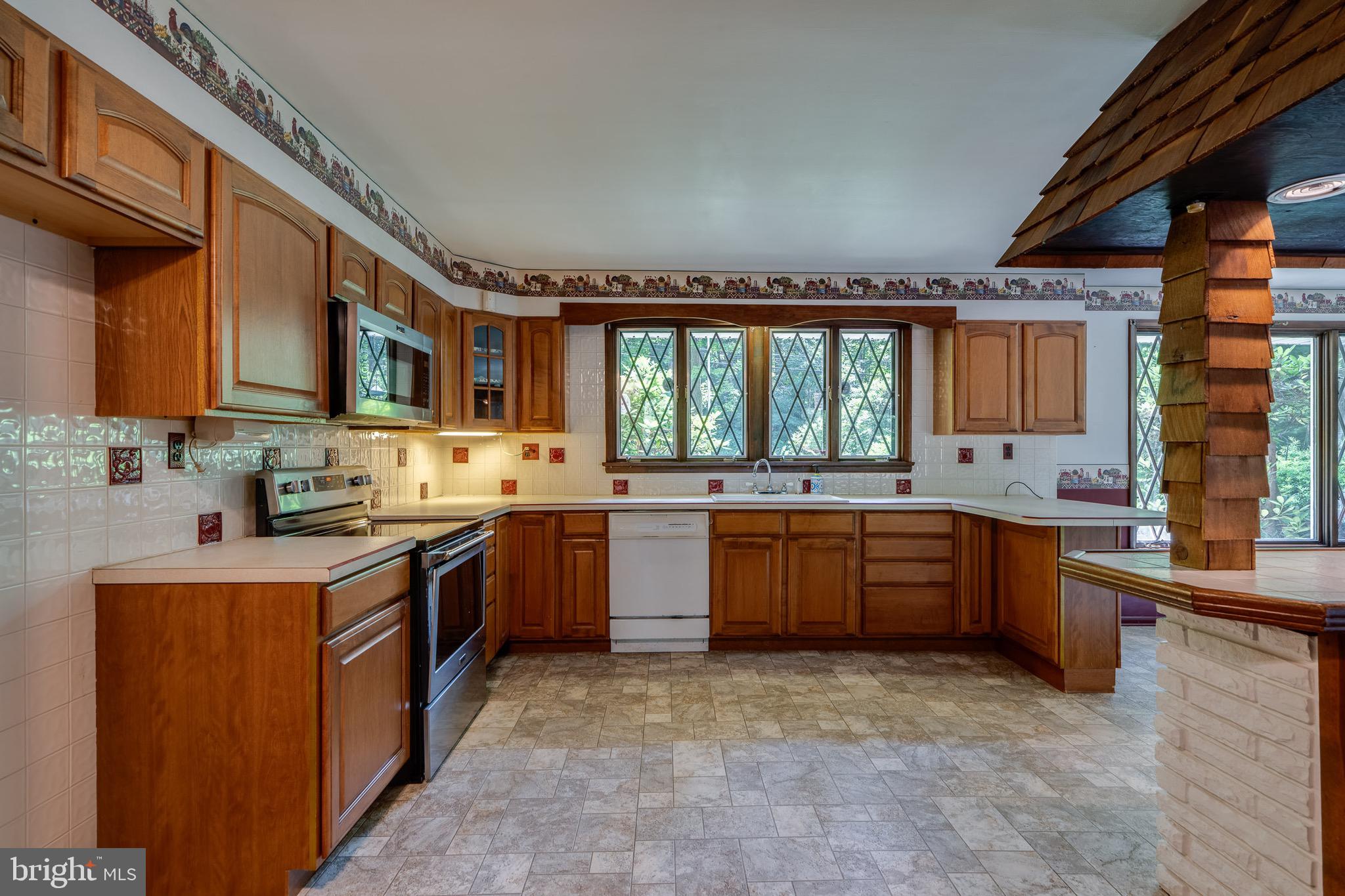 1111 Pennsy Road Pequea, PA 17565 - Photo 14 of 44 a kitchen with stainless steel appliances granite countertop a stove sink and cabinets