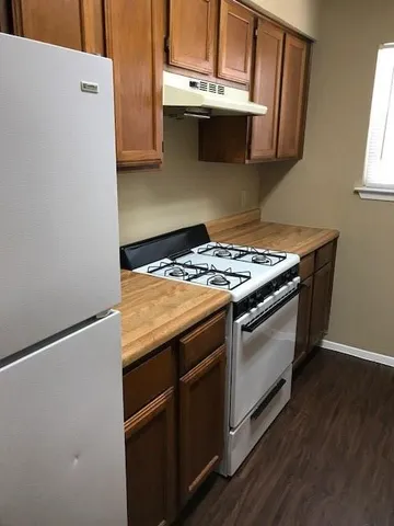 a stove top oven sitting inside of a kitchen