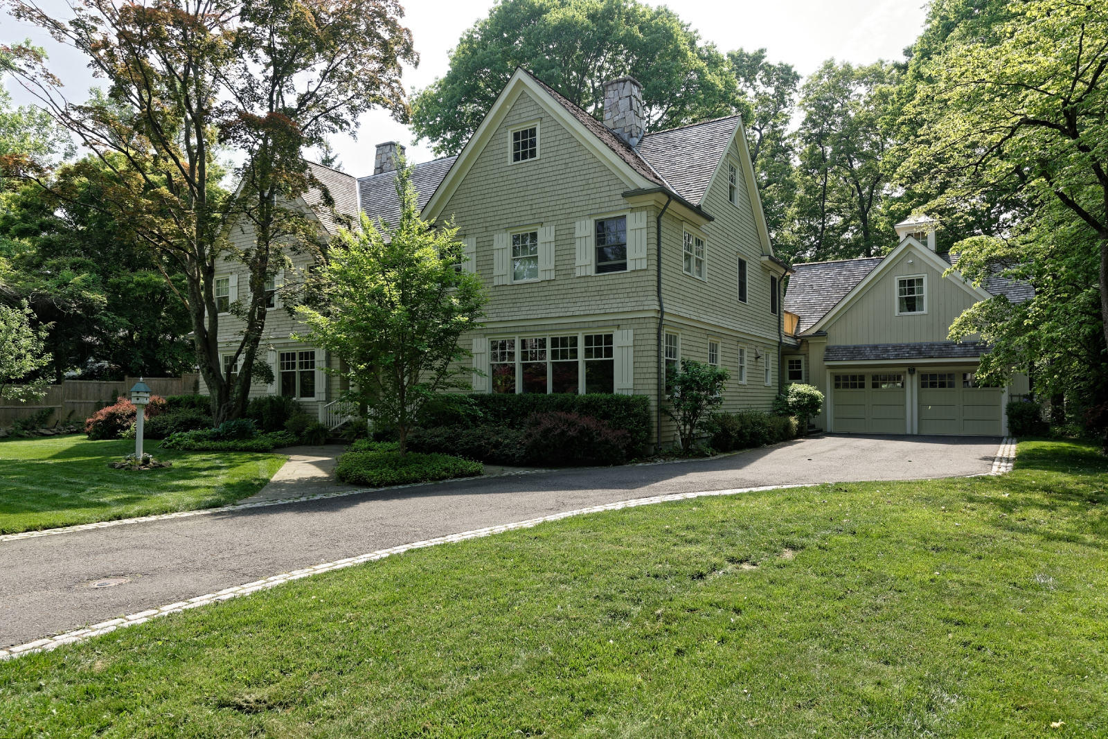 7 Ledge Road Rowayton, CT 06853 - Photo 22 of 30 a front view of a house with a yard and garage