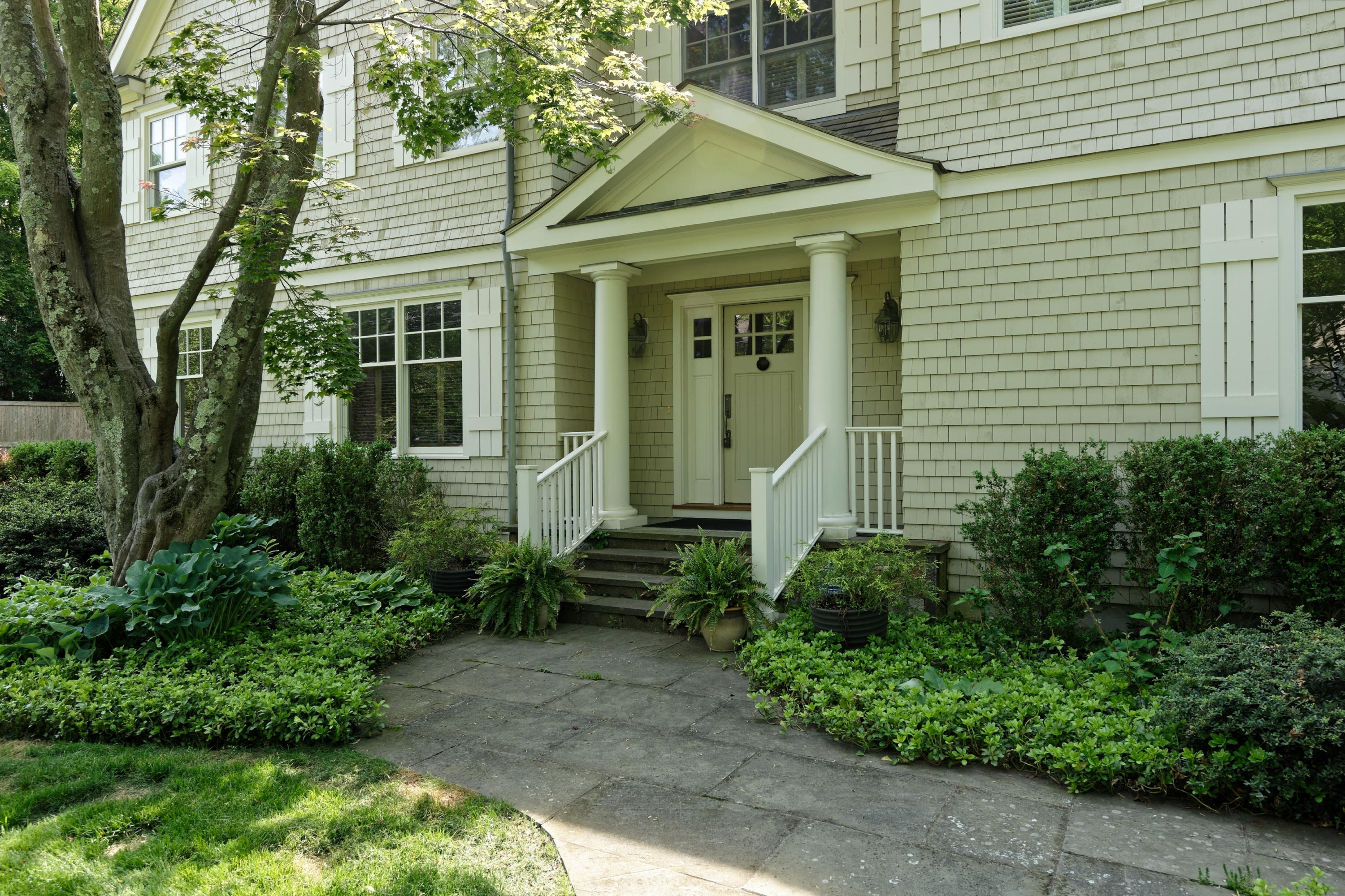 7 Ledge Road Rowayton, CT 06853 - Photo 23 of 30 a view of a house with brick walls and a yard with plants