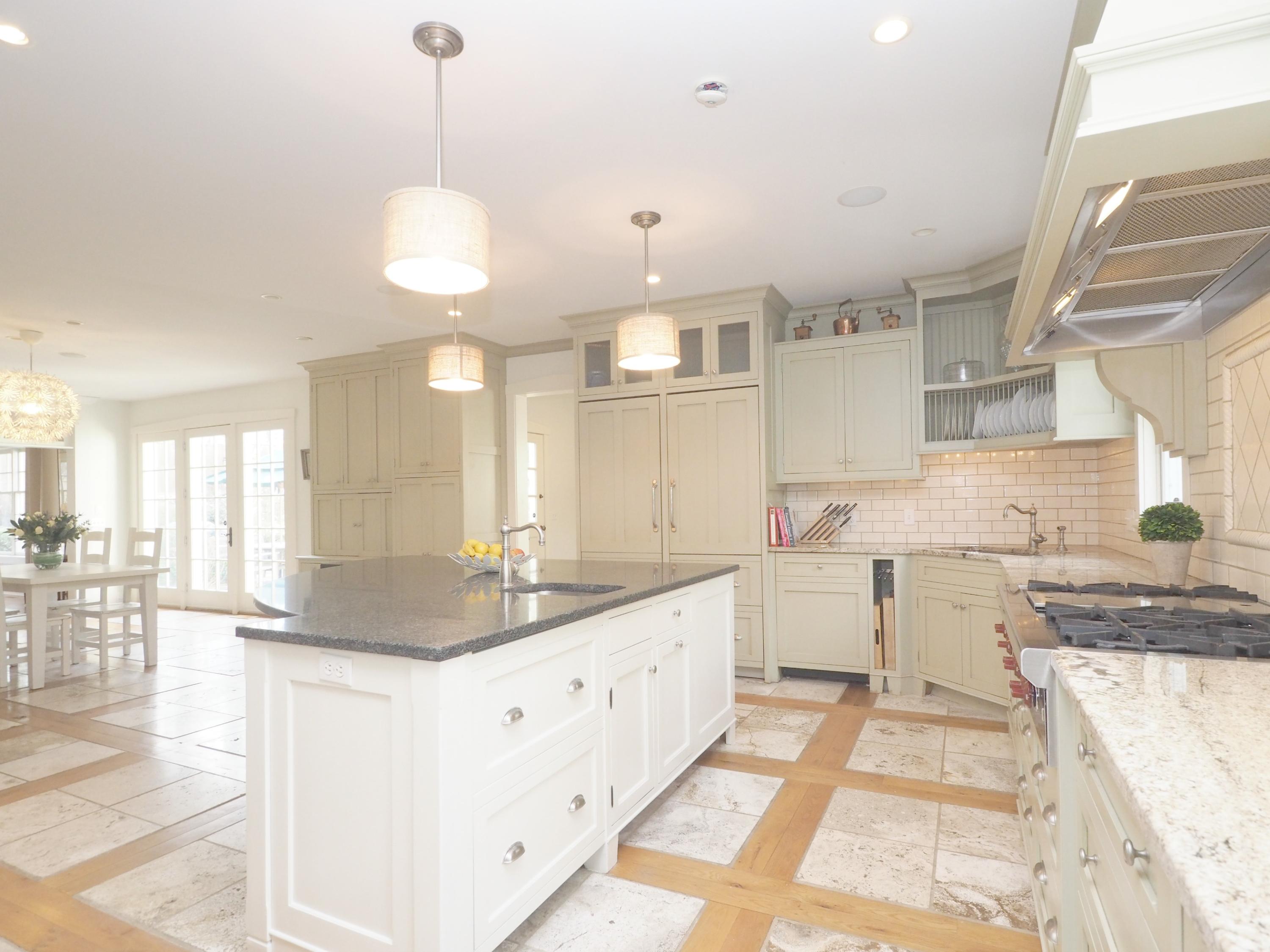 7 Ledge Road Rowayton, CT 06853 - Photo 7 of 30 a large white kitchen with a large counter top a sink a window and living room view