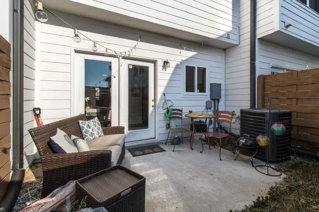a view of a patio with couple of chairs and a couch