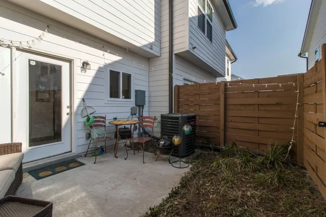a backyard of a house with outdoor seating