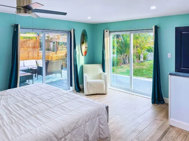 a bedroom with a large bed and a large window