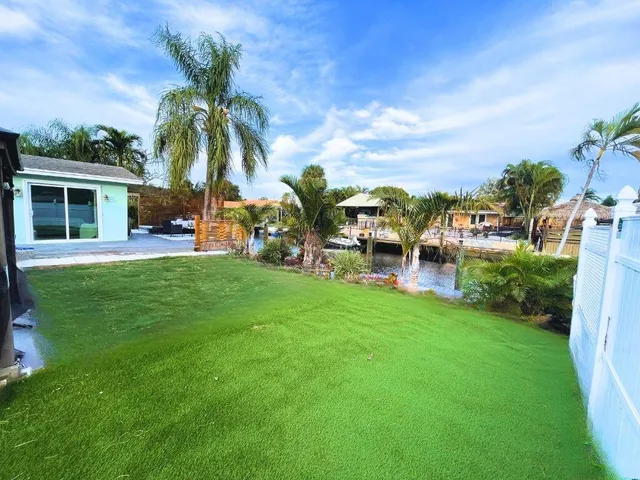 a view of a house with backyard porch and sitting area