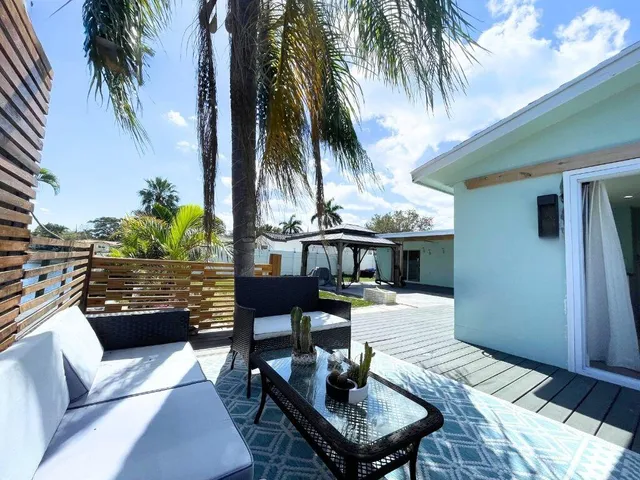 a view of a patio with swimming pool table and chairs