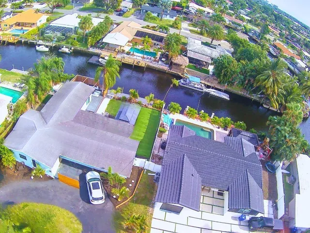 an aerial view of a house with a yard pool outdoor seating