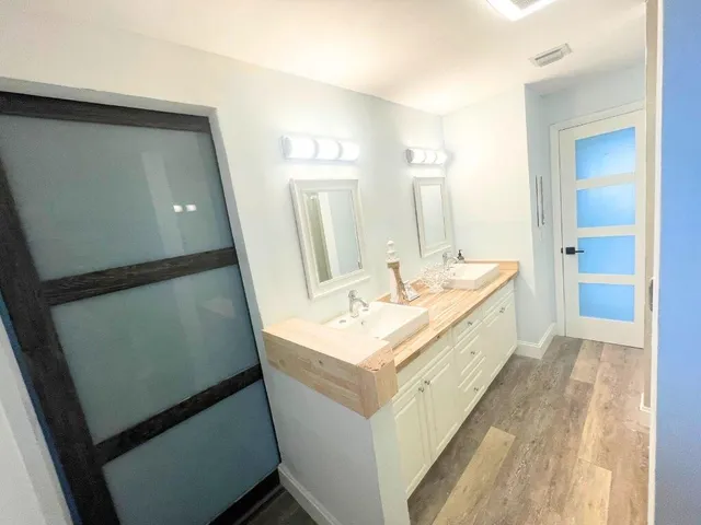 a bathroom with a sink a mirror and a shower