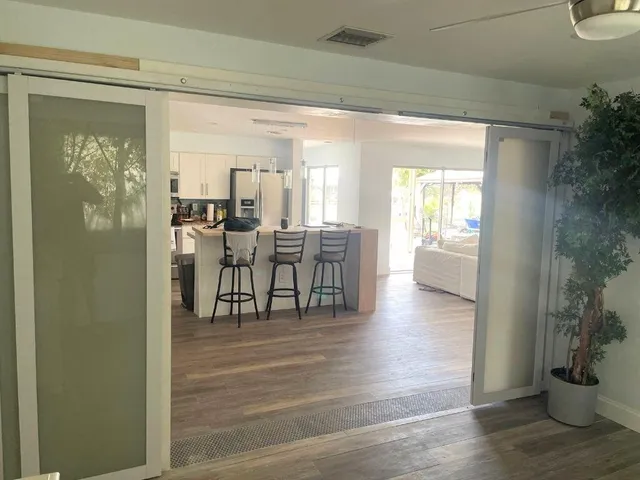 a view of a dining room with furniture and wooden floor