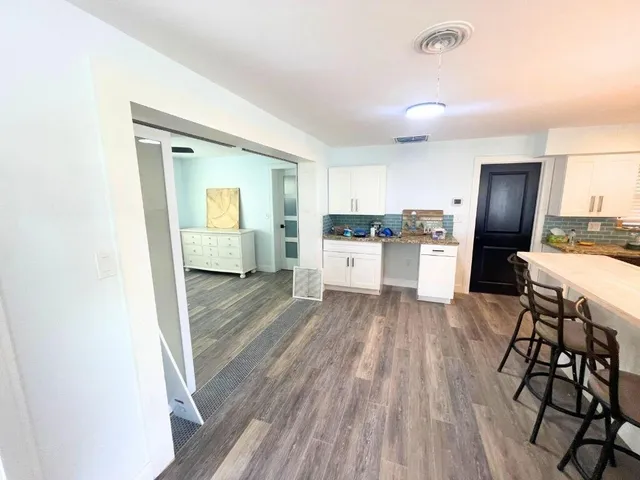 a view of kitchen with sink microwave and refrigerator