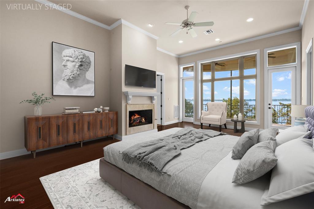 1 Lake Point Place Shreveport, LA 71119 - Photo 21 of 38 a bedroom with a balcony a bed and a fireplace