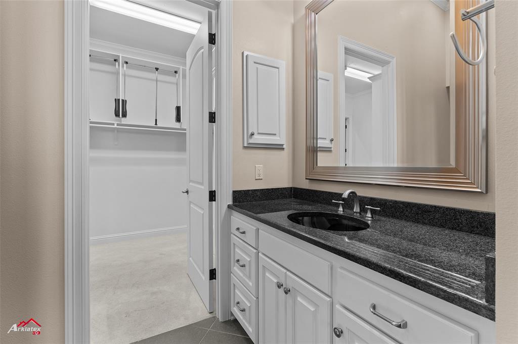 1 Lake Point Place Shreveport, LA 71119 - Photo 22 of 38 a bathroom with a granite countertop sink and a mirror