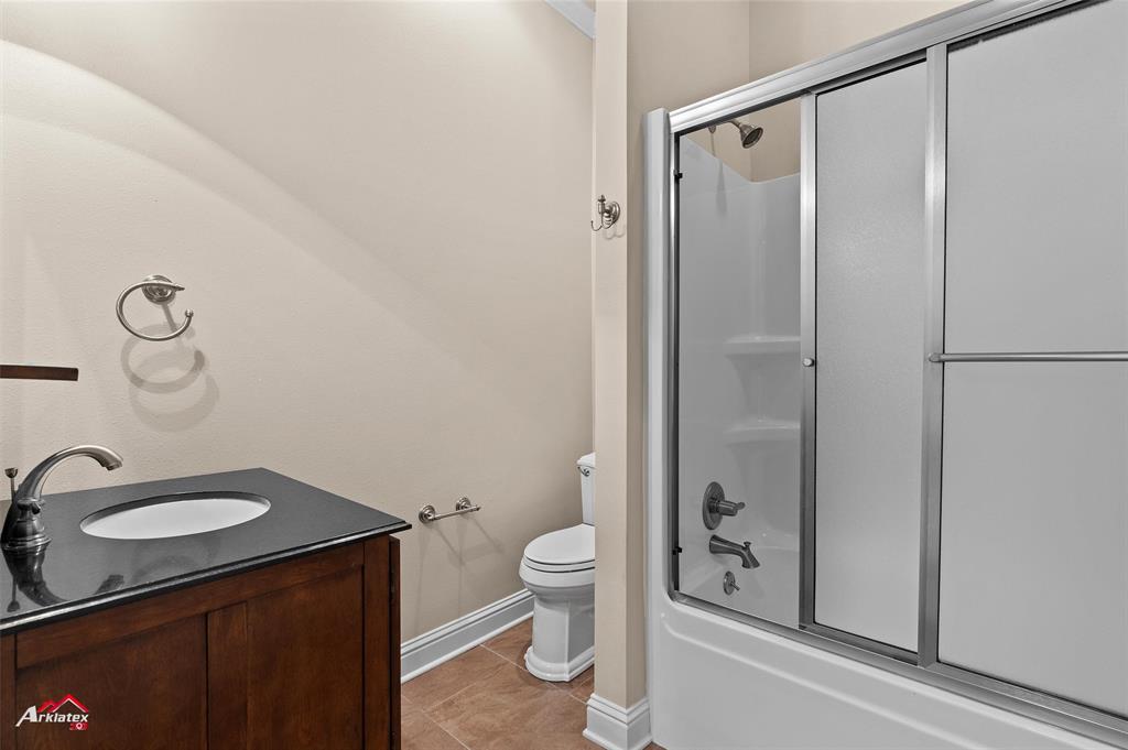 1 Lake Point Place Shreveport, LA 71119 - Photo 33 of 38 a bathroom with a granite countertop sink toilet and shower