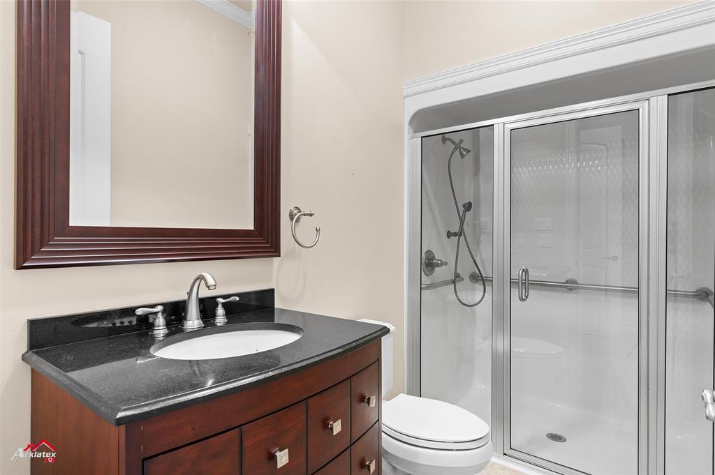 1 Lake Point Place Shreveport, LA 71119 - Photo 38 of 38 a bathroom with a granite countertop sink toilet a mirror and shower