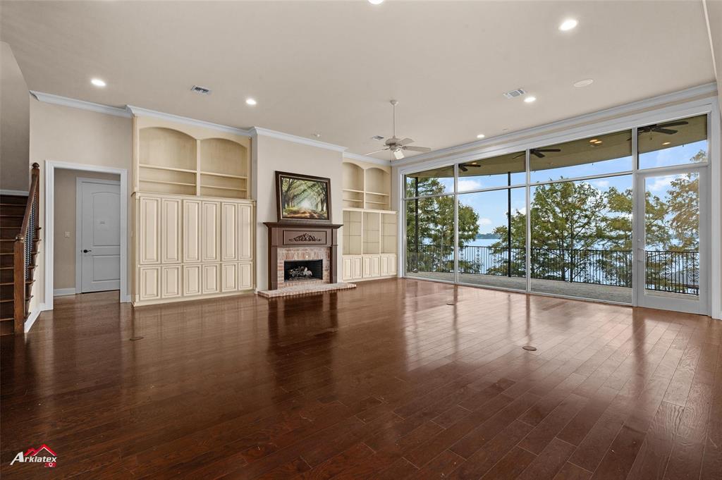 1 Lake Point Place Shreveport, LA 71119 - Photo 6 of 38 a view of empty room with wooden floor and fireplace