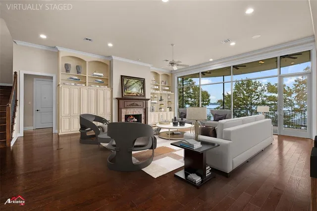 a view of a dining room and livingroom with furniture wooden floor a chandelier
