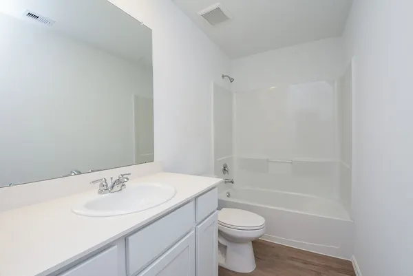 a bathroom with a sink a toilet and vanity