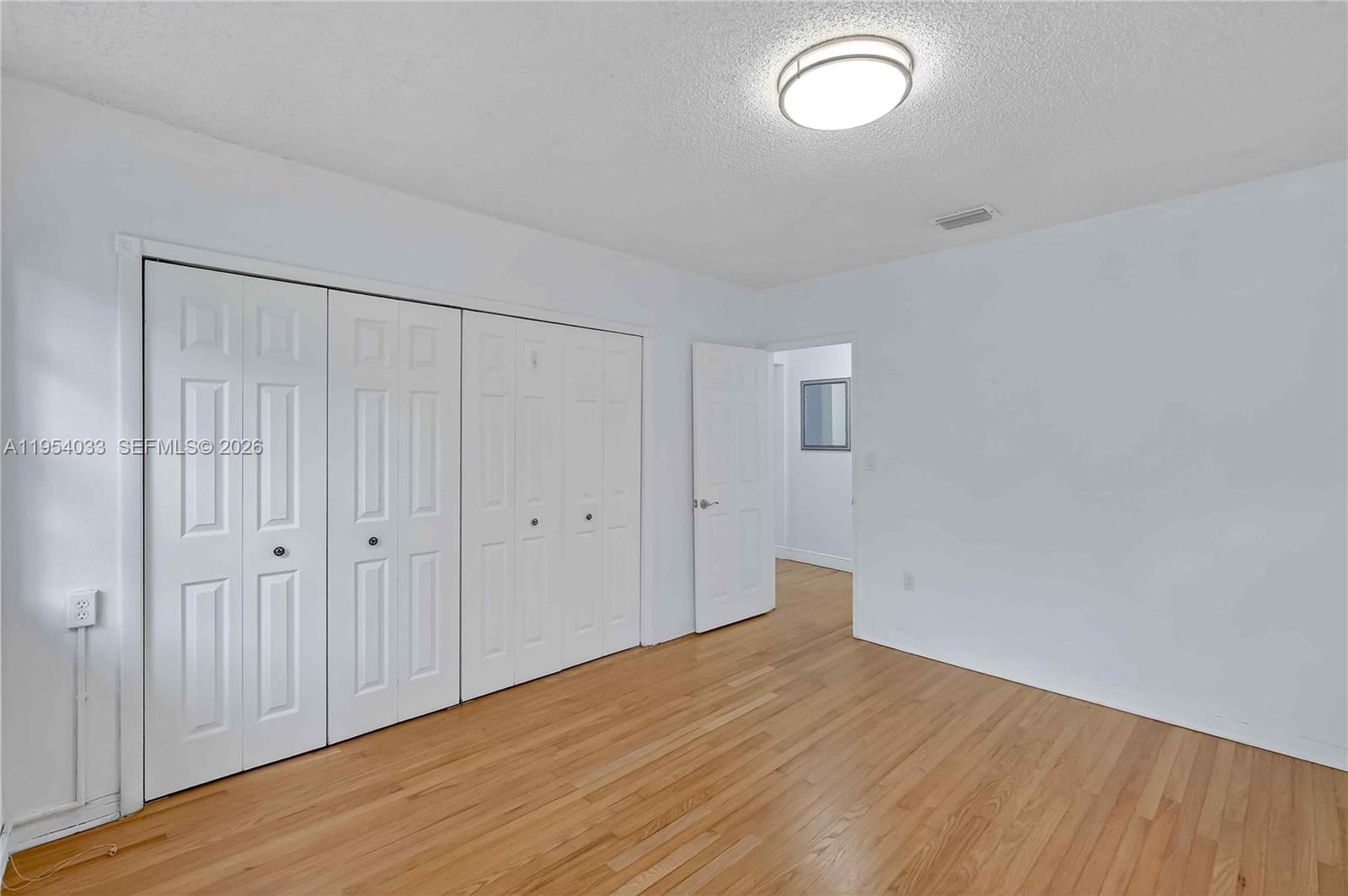 2399 Southwest 26th Lane Miami, FL 33133 - Photo 23 of 39 a view of empty room with wooden floor