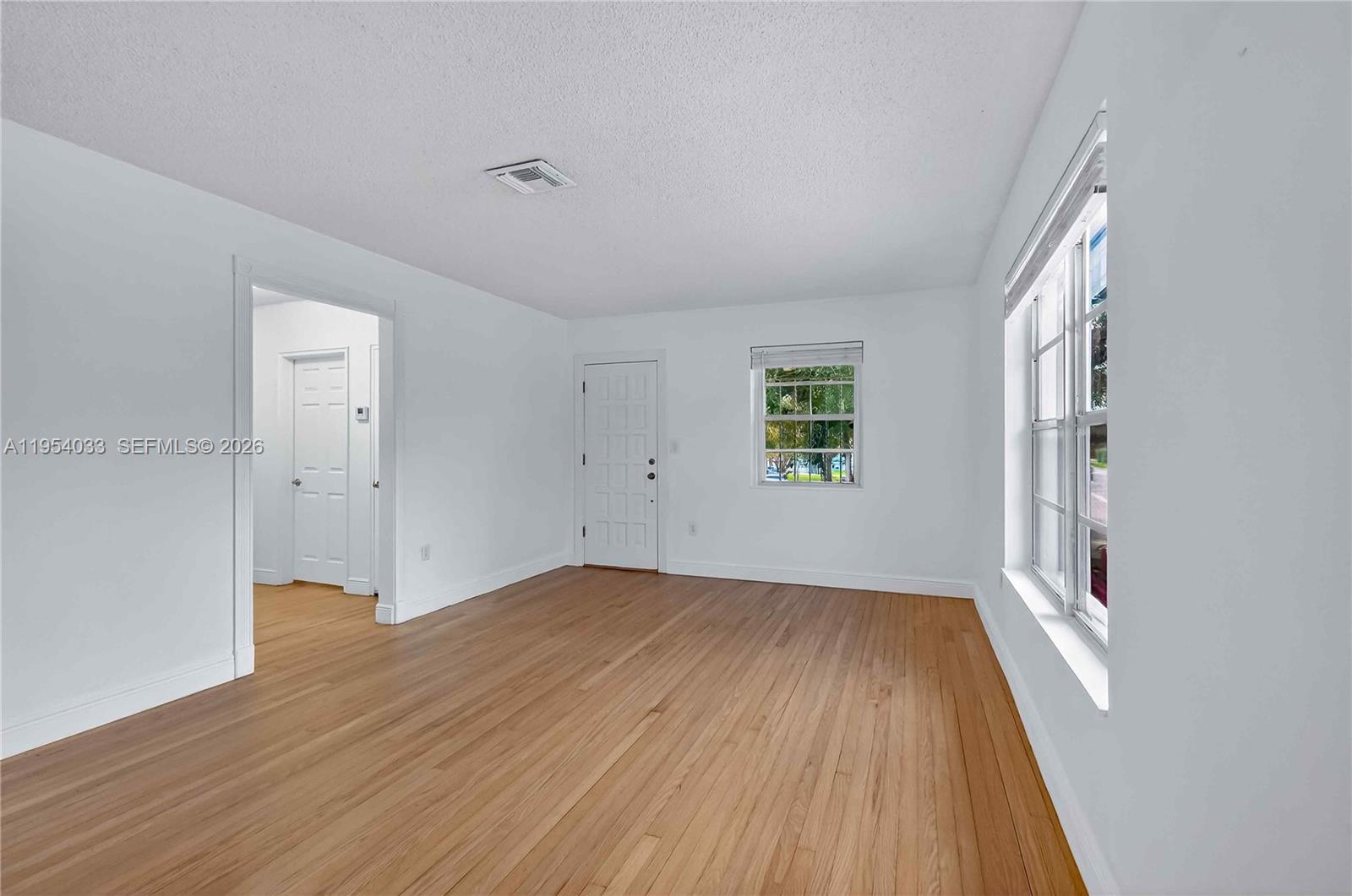 2399 Southwest 26th Lane Miami, FL 33133 - Photo 26 of 39 wooden floor in an empty room with a window