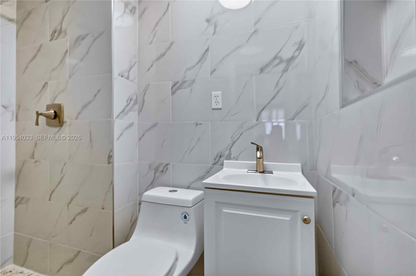 2399 Southwest 26th Lane Miami, FL 33133 - Photo 30 of 39 a bathroom with a sink toilet and shower