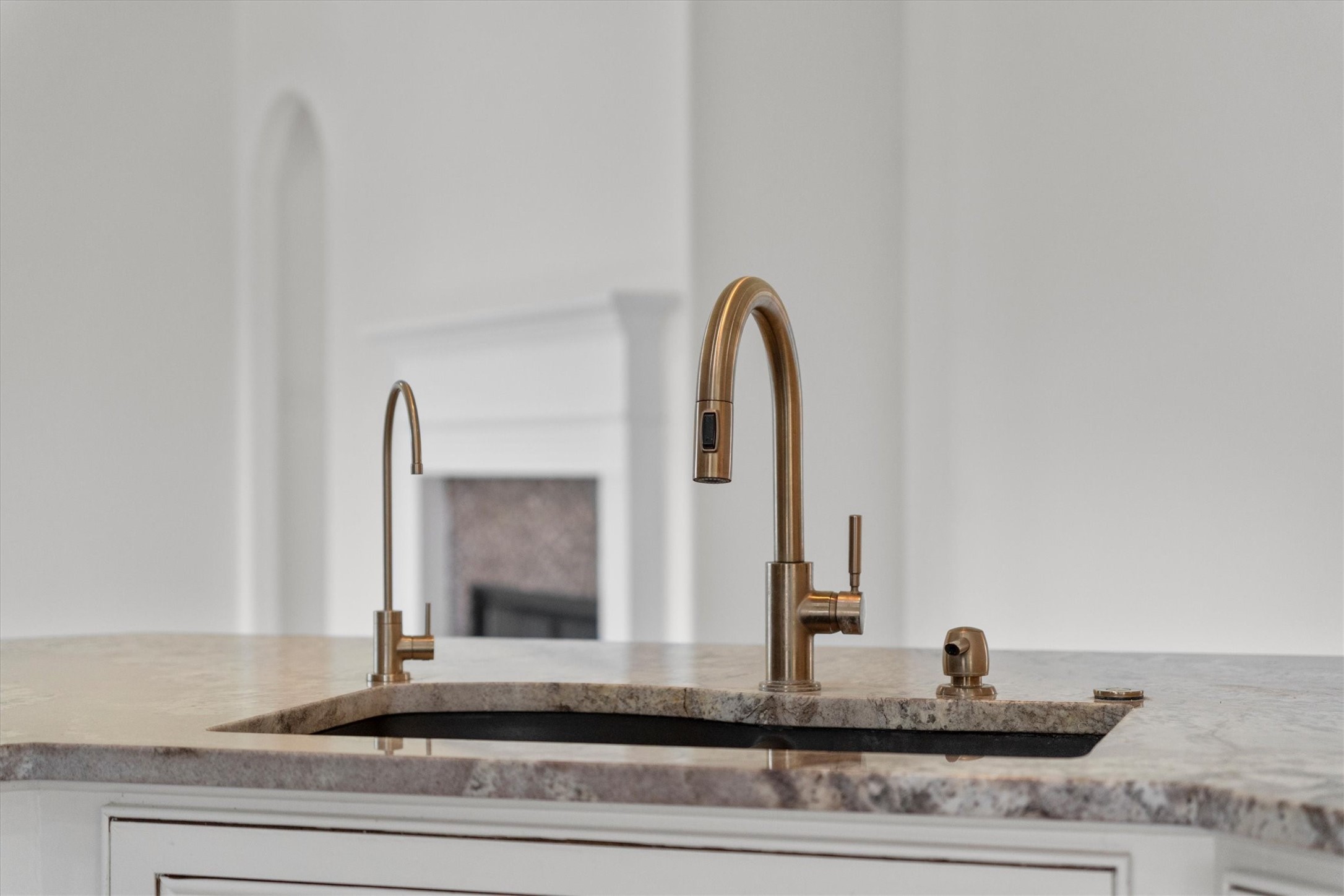 2507 Grayfeather Court Spring, TX 77388 - Photo 13 of 37 Stylish brass faucet set against a sleek countertop elevate the look and feel of the kitchen.