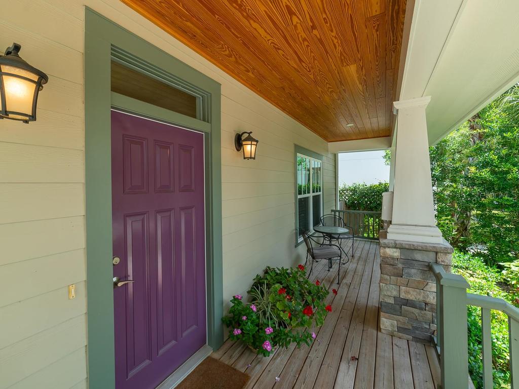 Relaxing front porch with pine ceilings